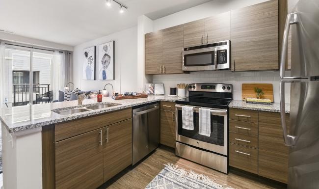 a kitchen with stainless steel appliances and granite countertops