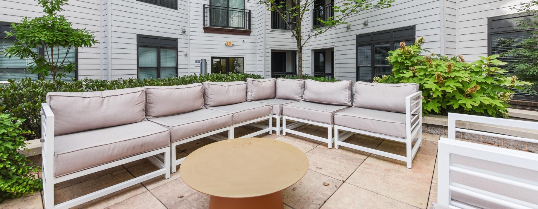 a white couch in a courtyard in front of a building