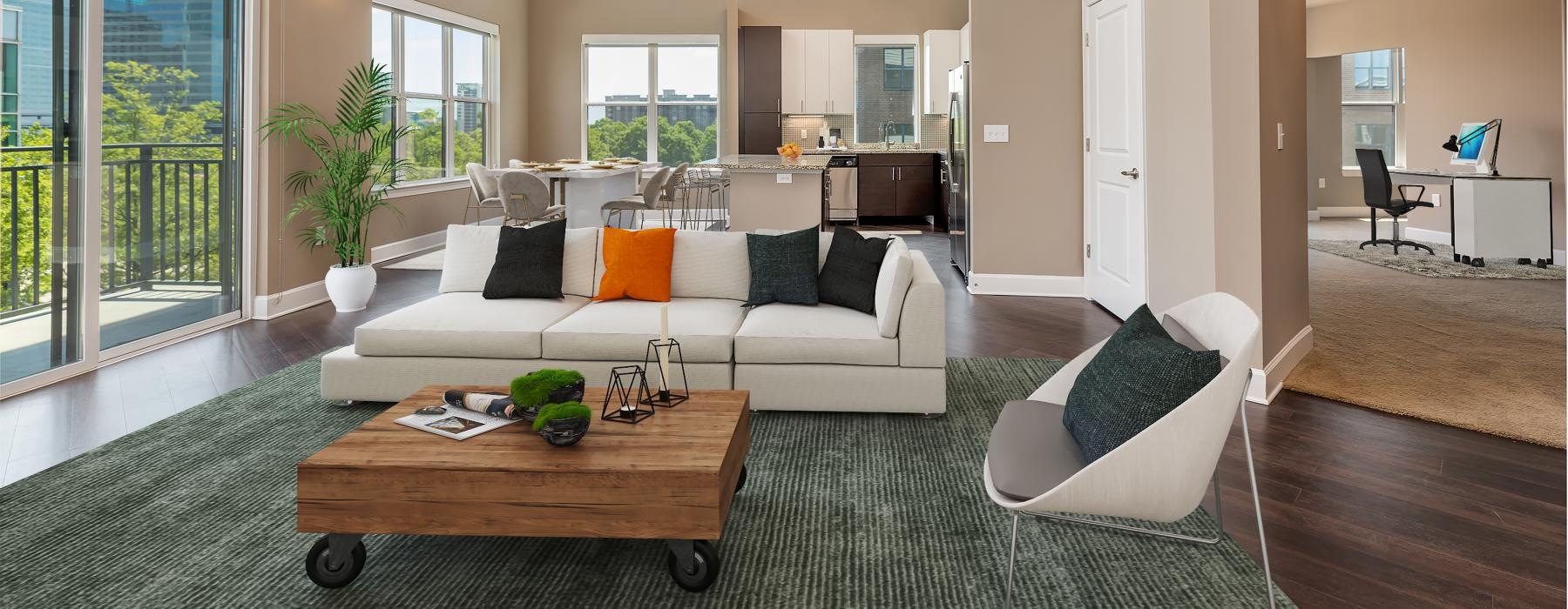 a living room with a couch and a coffee table and many windows